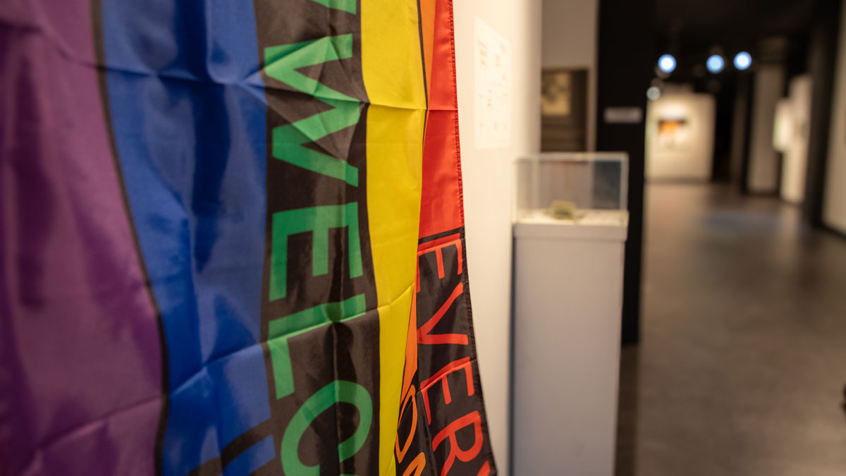 LGBTQ flag hanging in a museum exhibit.