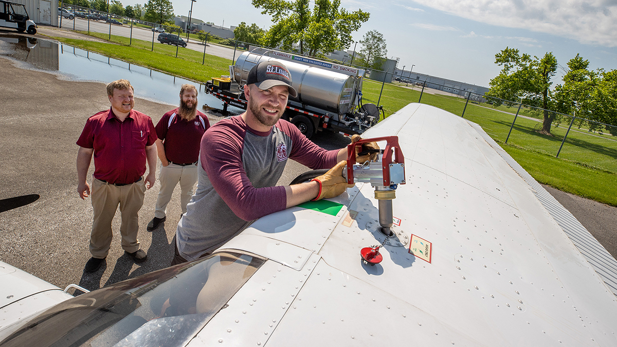 A man is fueling a plane.
