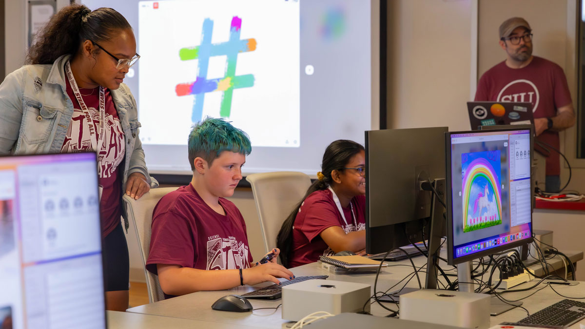 Kids making art on computers.