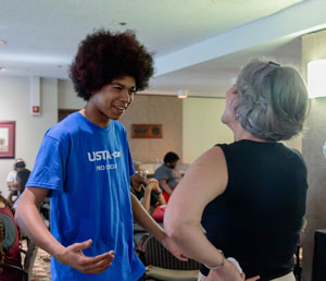 A young man and older woman are talking.