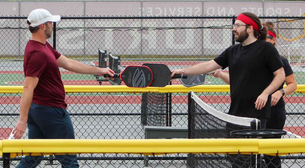 Two men playing pickleball.