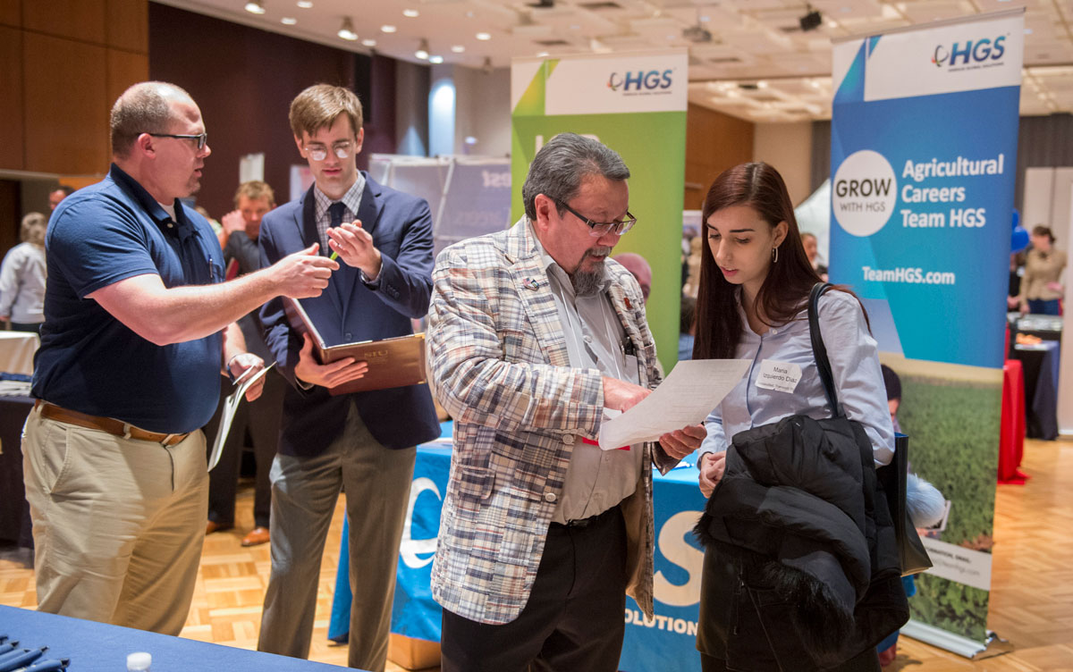 Students talk with businesses at a job fair.