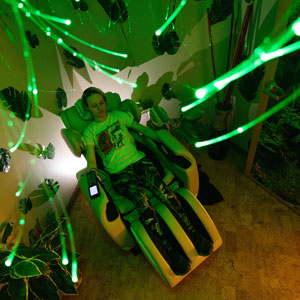 A student is relaxing in the Rainforest Room.