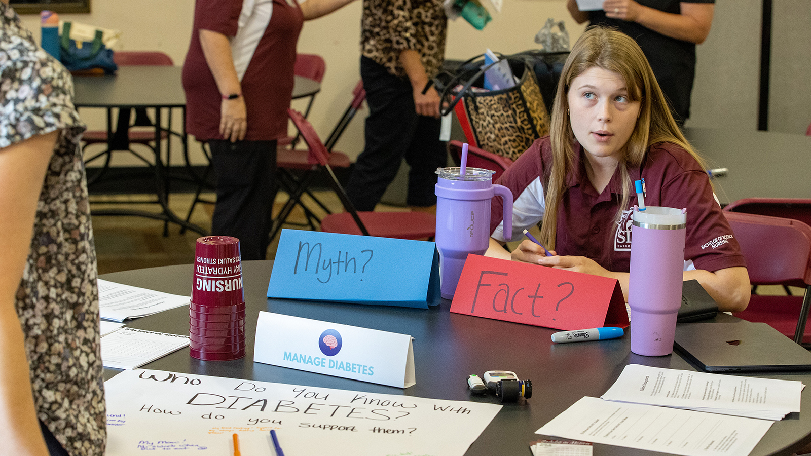 Students help participants learn about diabetes.