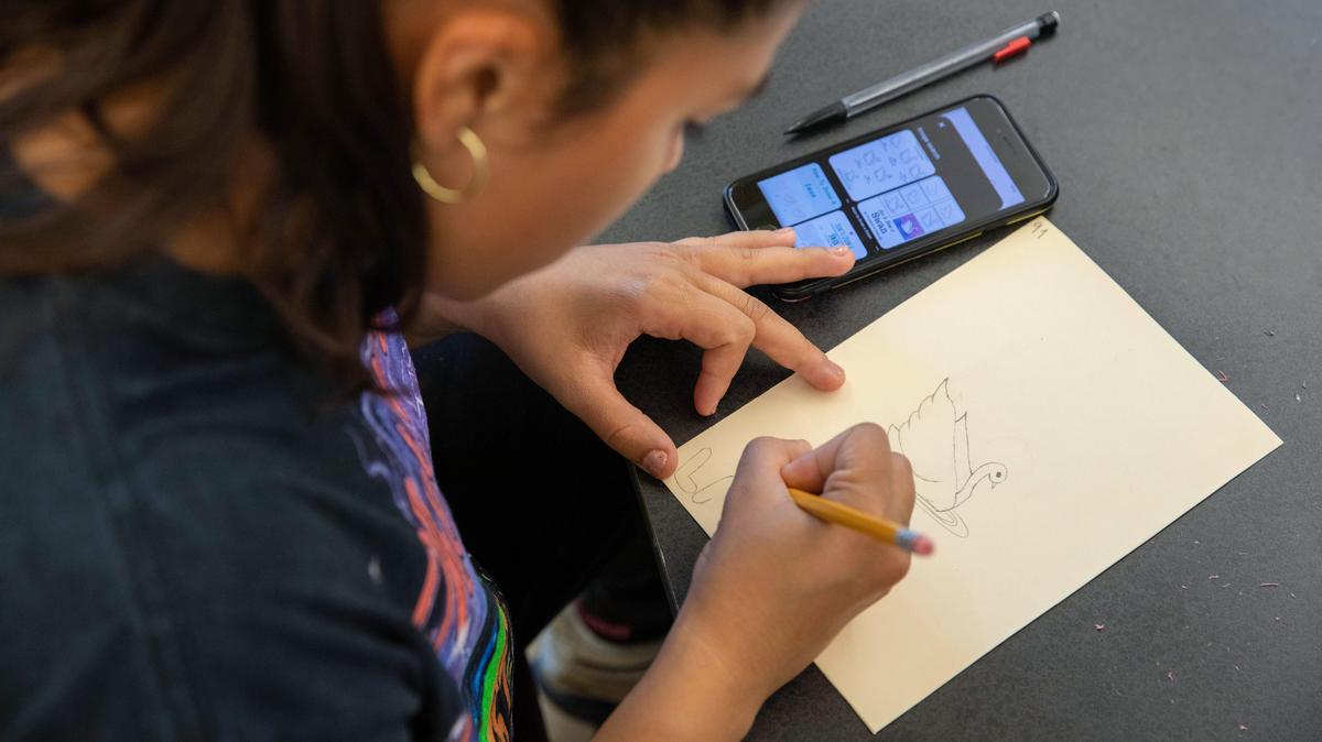 A woman works on making her own loteria (bingo) card for Hispanic Heritage Month.