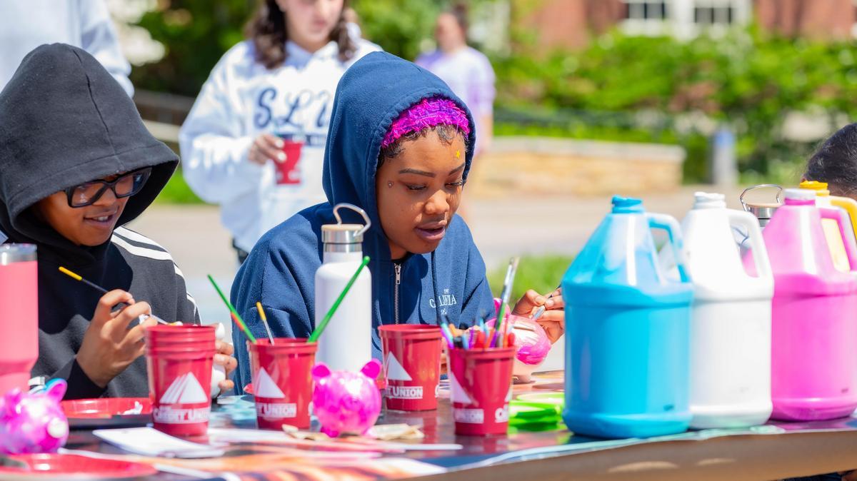 Students enjoy a painting activity at Salukis Care Day.