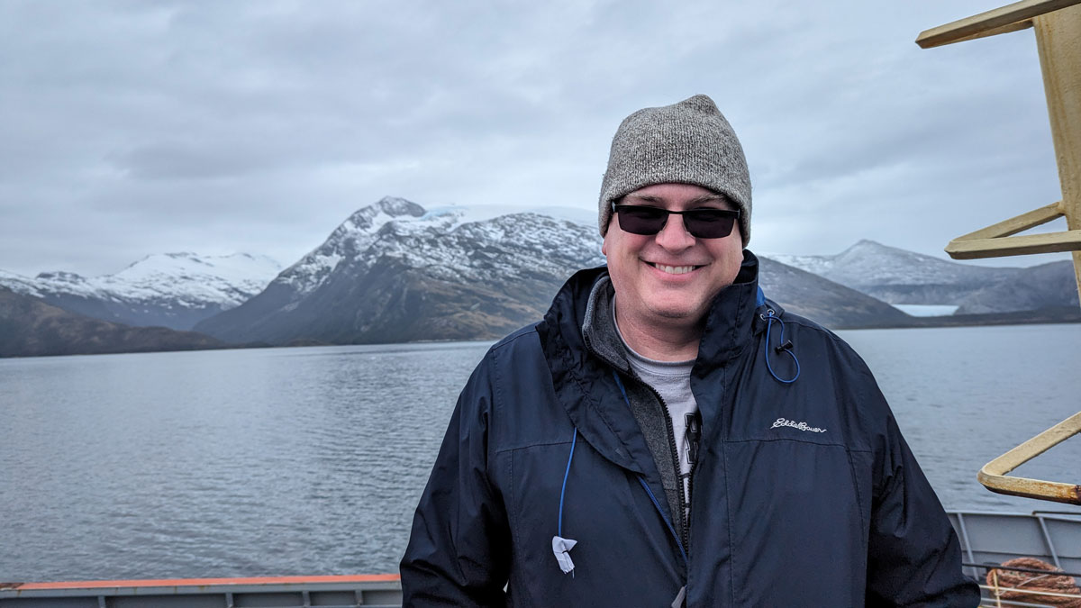 James Conder is pictured in front of mountains in South America.