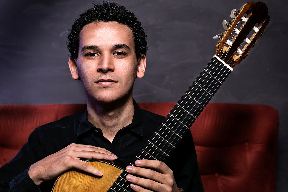 João Vitor holding a guitar.
