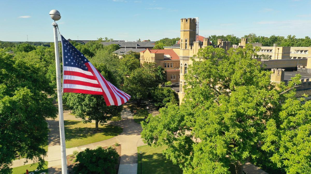 Aerial view of the American flag with Altgeld Hall in the background.