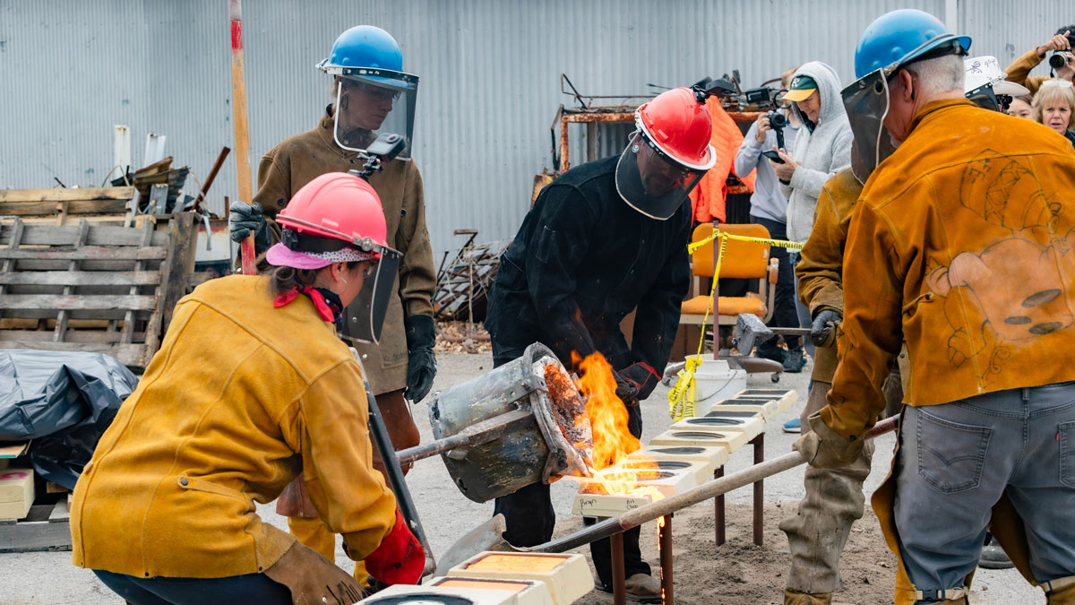Students participating in an iron pour.