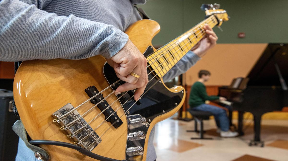 A person playing an electric guitar.