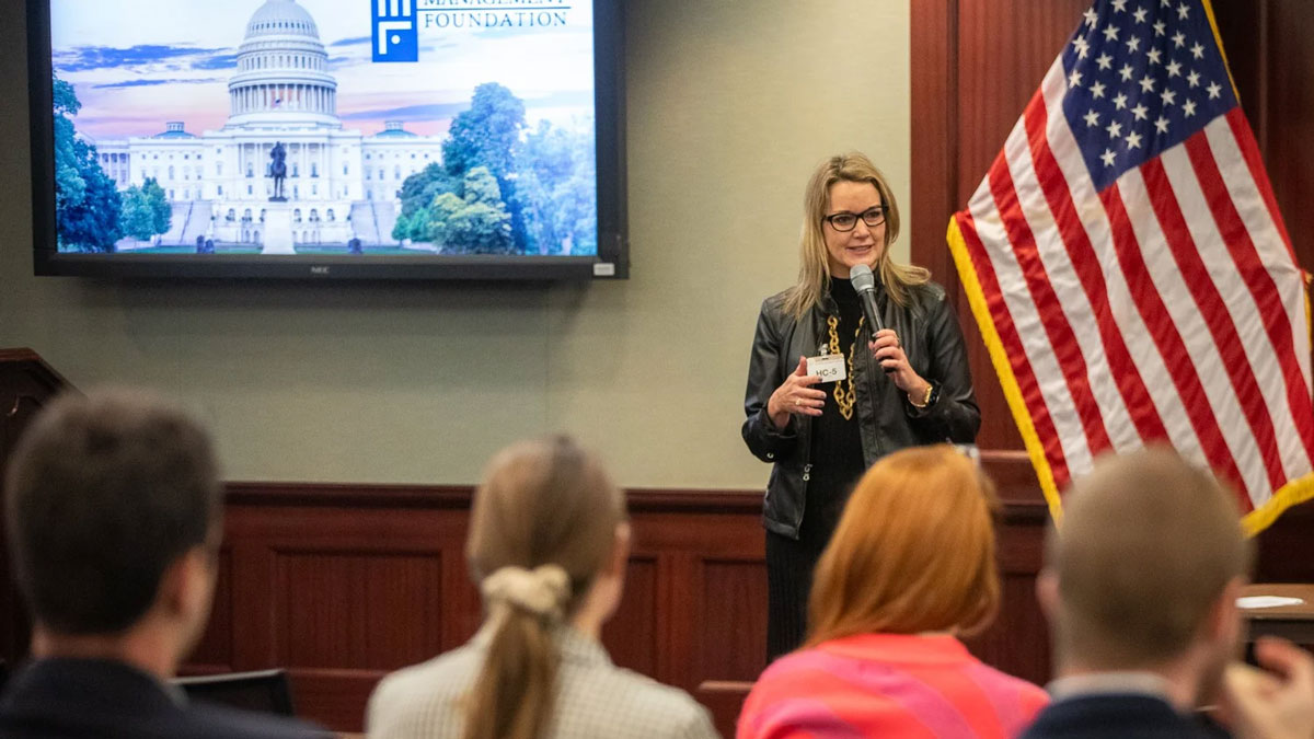 Jen Daulby speaking to a group of people.