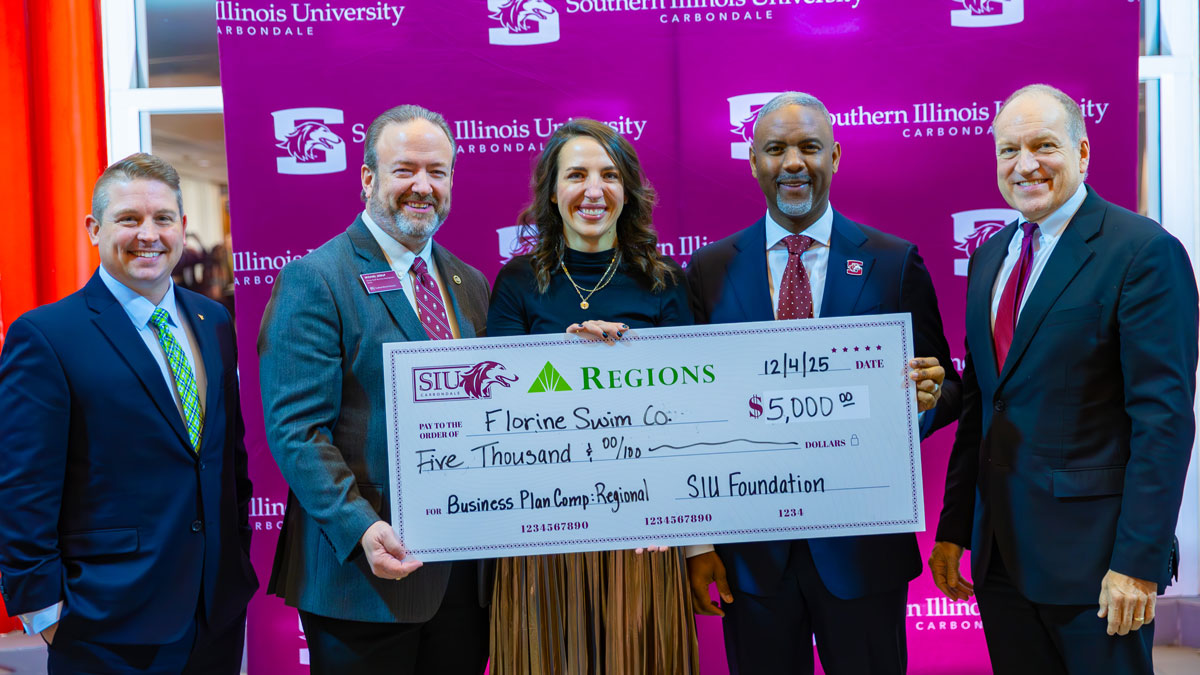 Innovation winner receives a check.