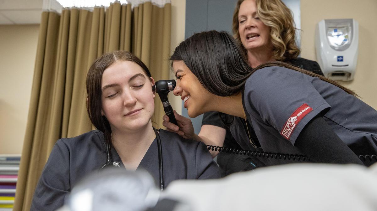 Nursing students practicing in the classroom.