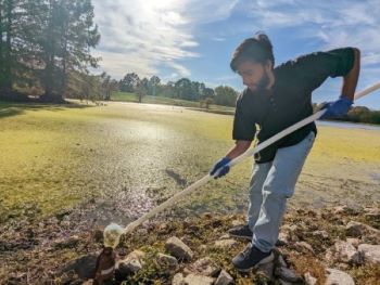 Dewasis Dahal works in field near the SIU campus
