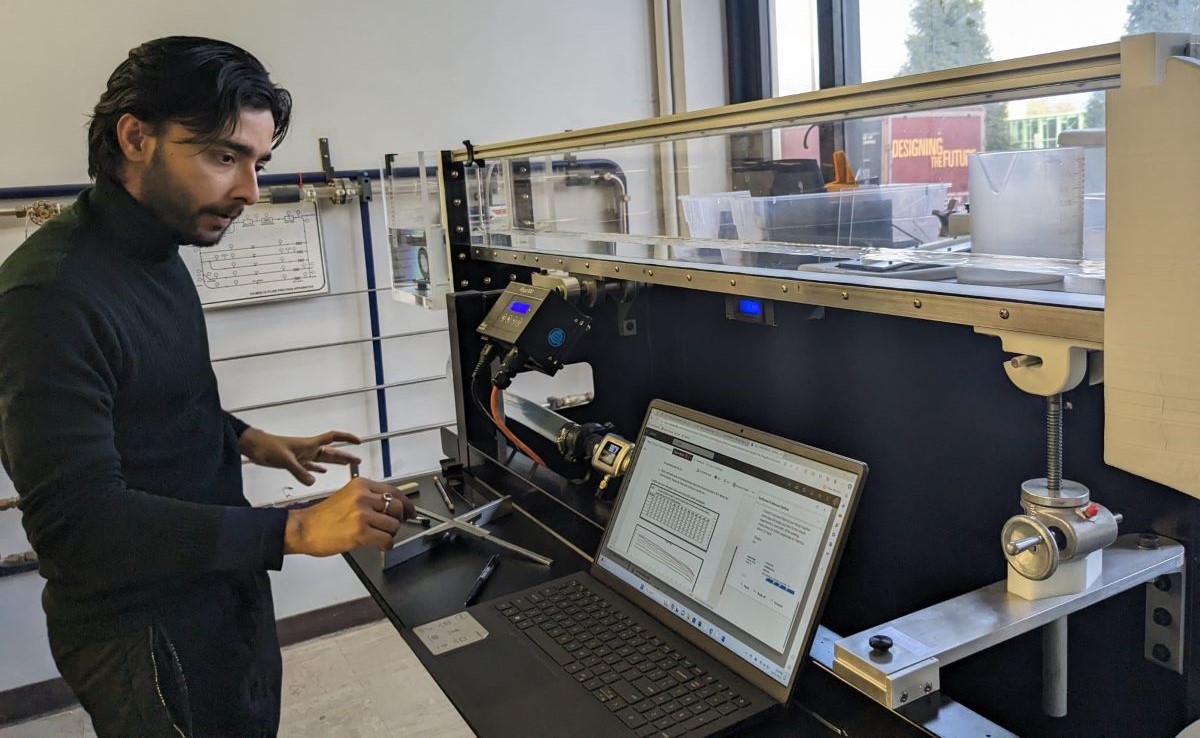 SIU Carbondale graduate Dewasis Dahal works in an SIU lab to calibrate hydraulic experiments.  