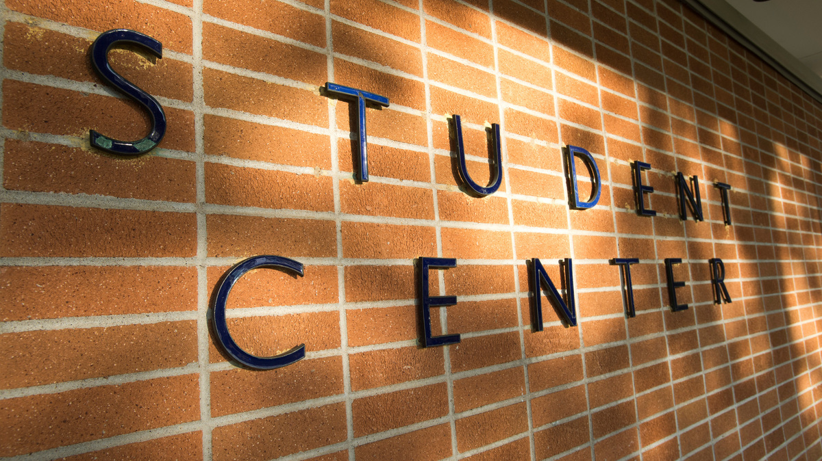 The wall on a building that says Student Center.