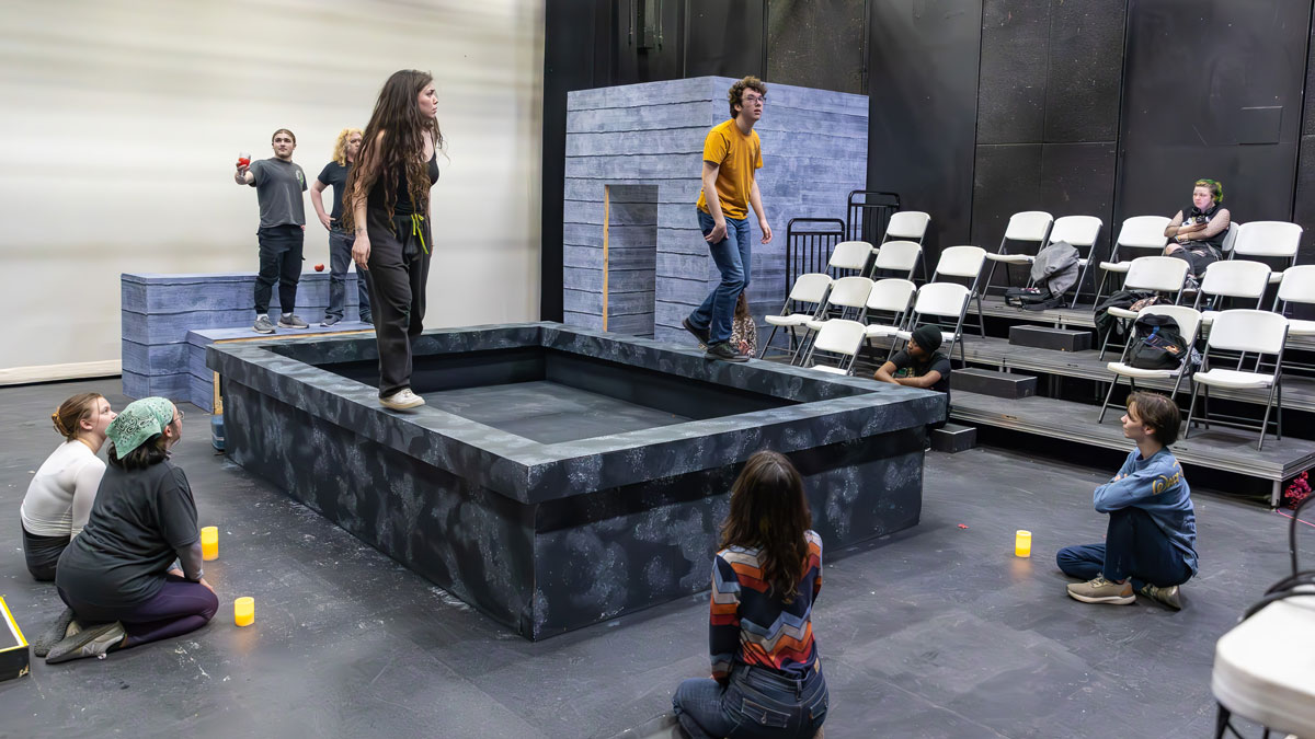 Cast members rehearse a play.