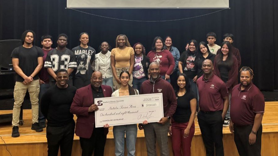 A student celebrates a scholarship win with Chancellor Lane.