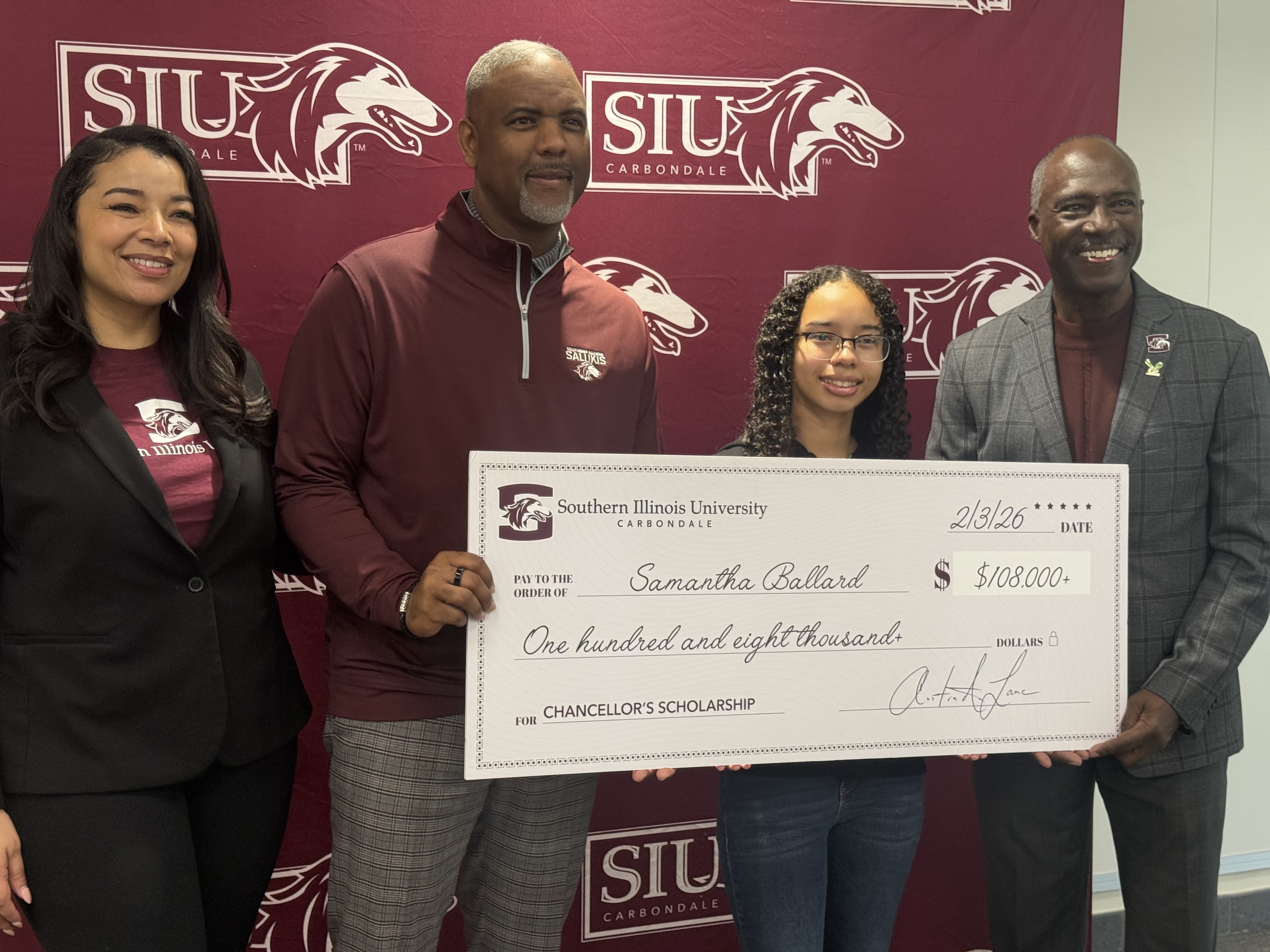 Chancellor Lane presents a check for a full scholarship to SIU Carbondale.