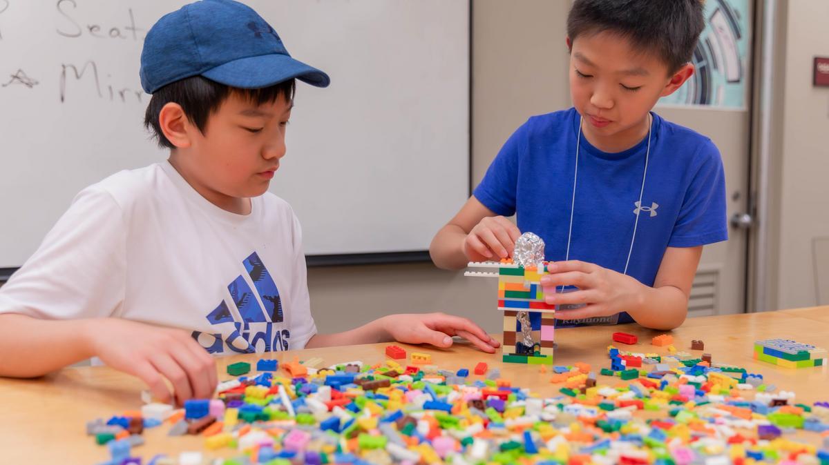 Children work on activities at Lego Camp.
