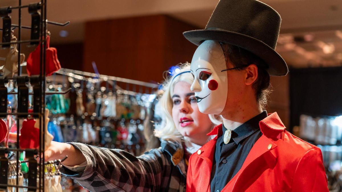 A cosplay participant gets help from a vendor at one of the many booths at Saluki Con.