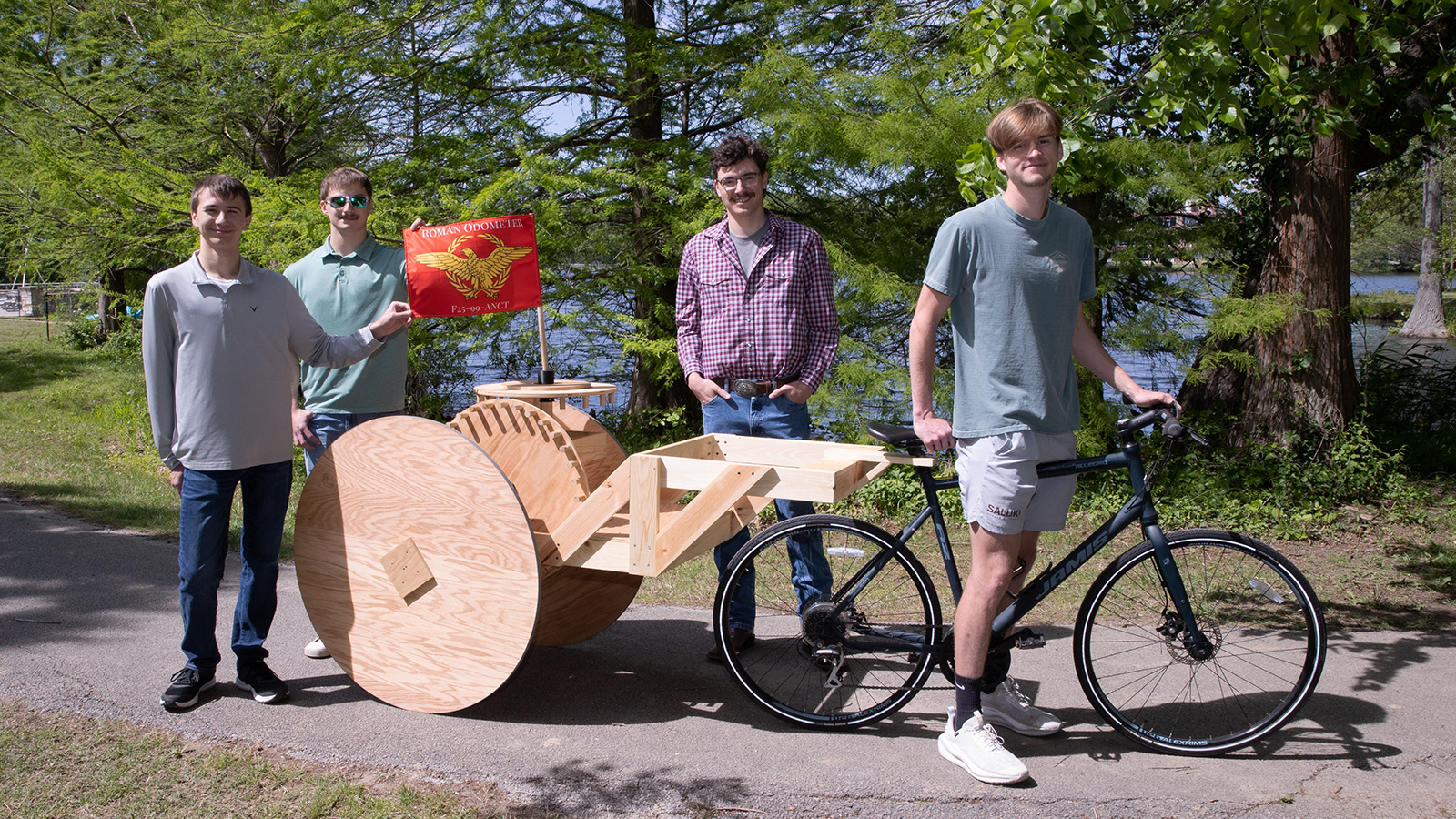 SIU Carbondale students and a replicated ancient Roman odometer.