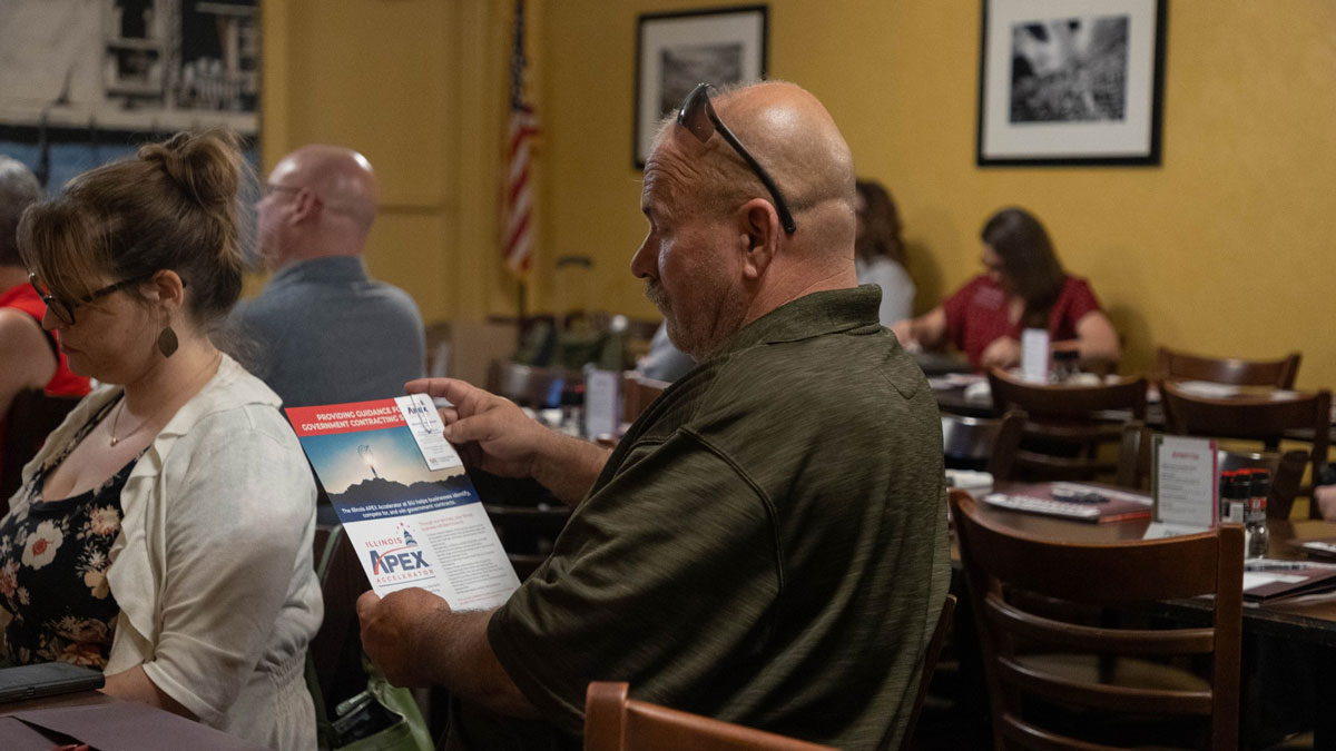Participants at an event listen to a speaker.