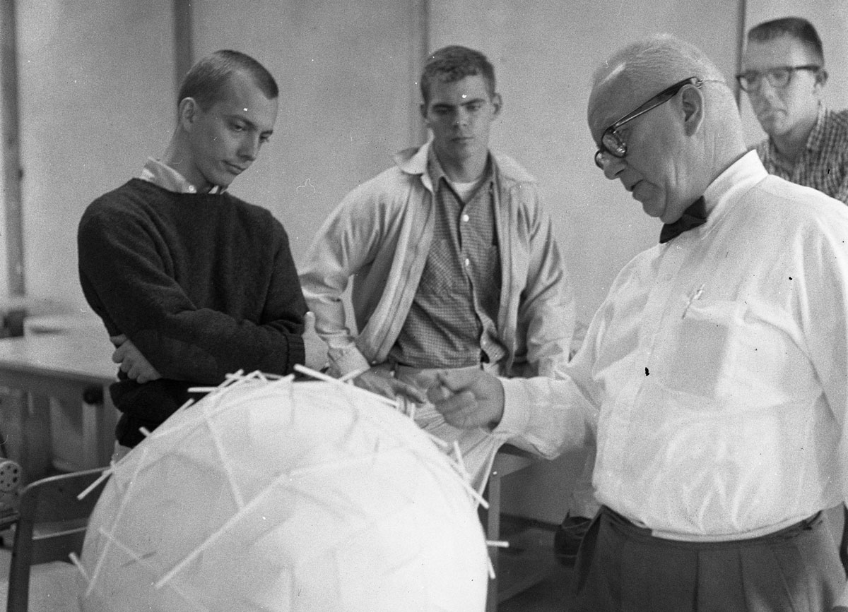 R. Buckminster Fuller speaking with students about the model of the dome.