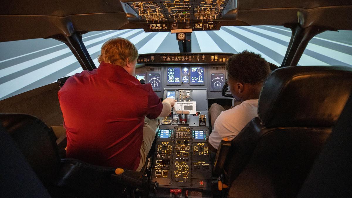Aviation simulator being used by summer camp participants.