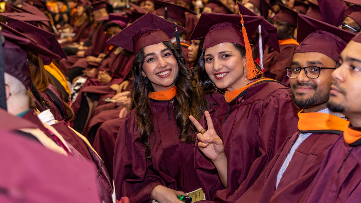 Graduates pose for a picture at commencement.