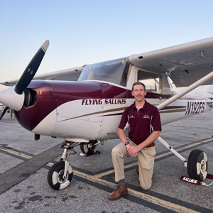 Ben Campbell beside an airplane.