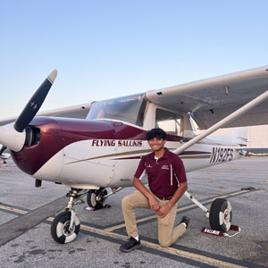 Kroosh Patel next to an airplane.