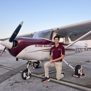 Thomas Nguyen next to an airplane.