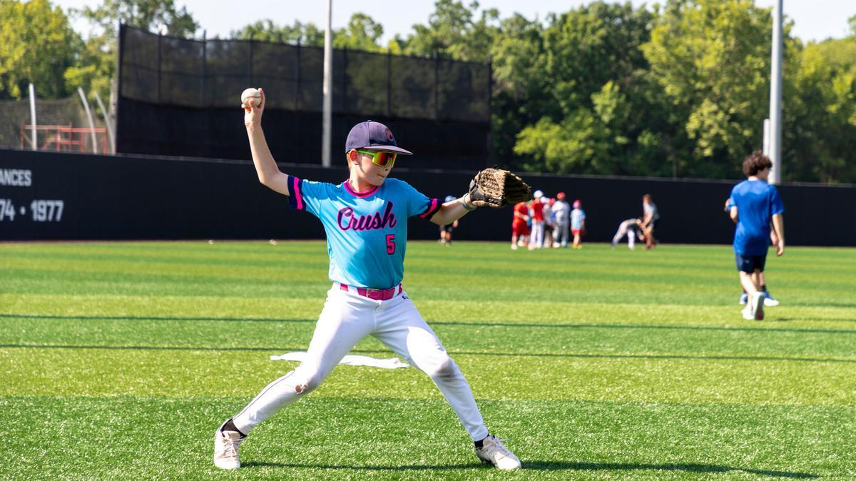 Camp participant throwing a ball at baseball camp at SIU Carbondale.