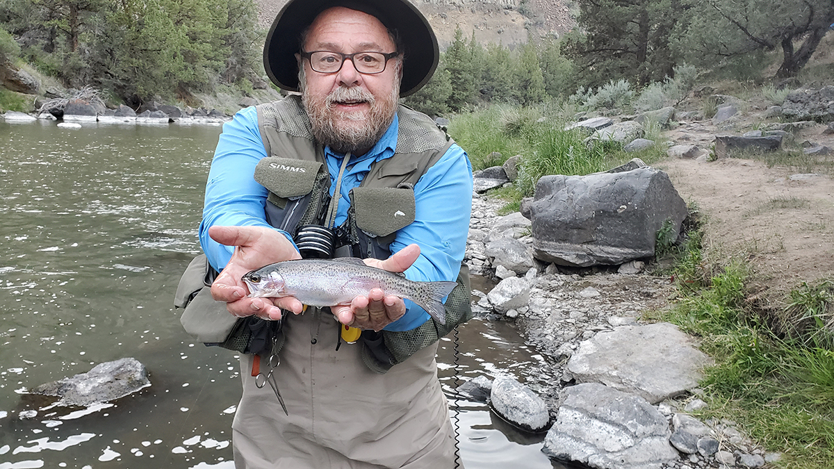 Ed Heist holding a rainbow trout.