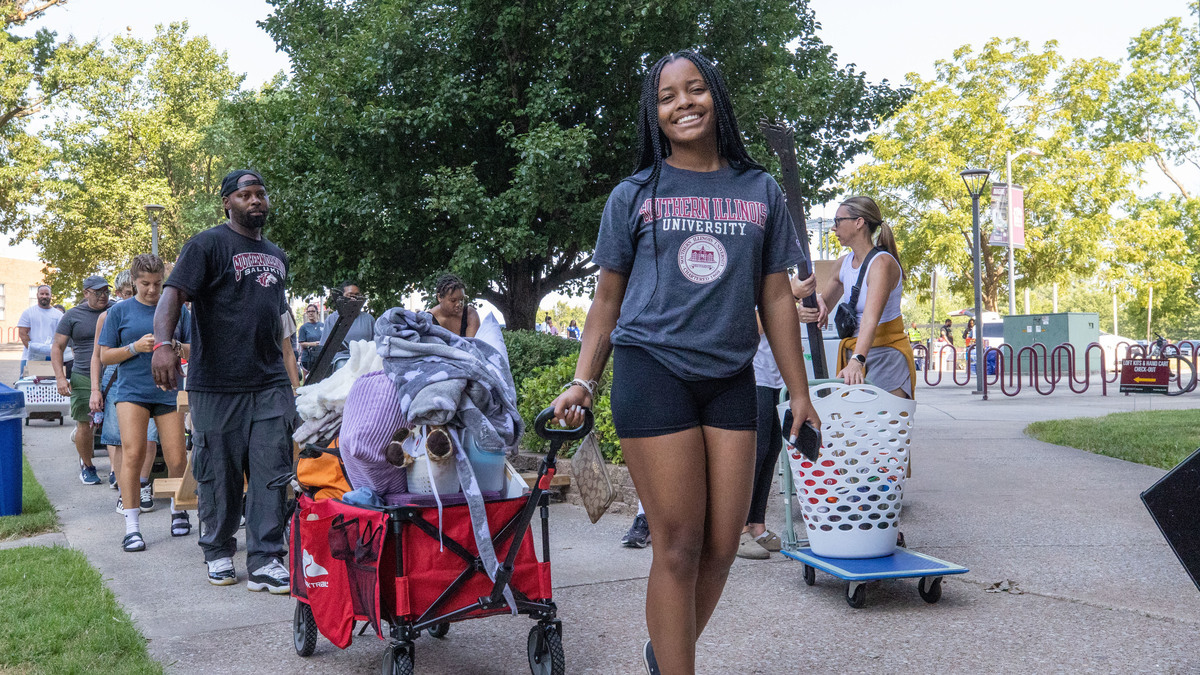 Students move into campus housing with the help of parents and volunteers.