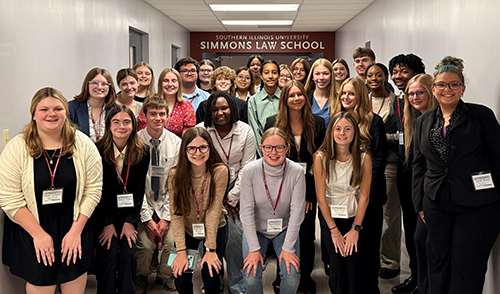 High school students from the Metro East stop for a group photo at a crime scene to courtroom program in June. 
