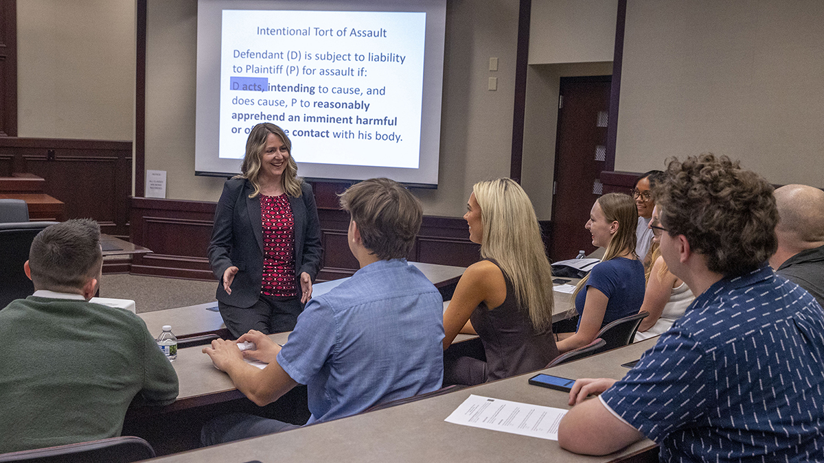 Angela Upchurch speaks with students in a classroom.