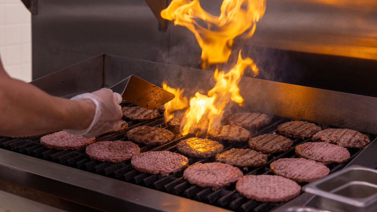 Hamburgers being flame grilled.