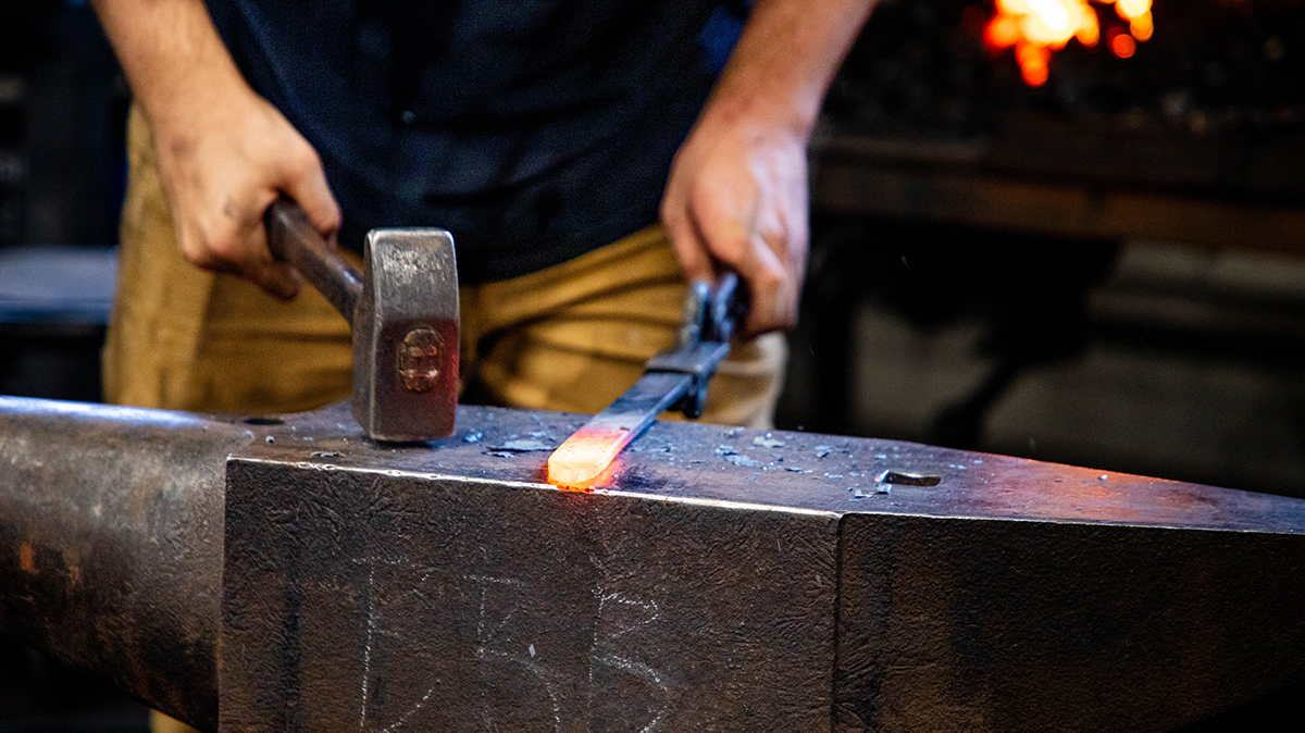 Upclose image of metalsmithing. 