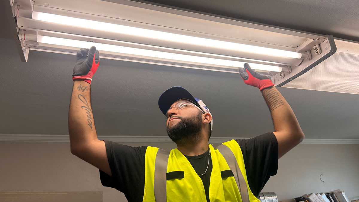 A man is changing light bulbs.