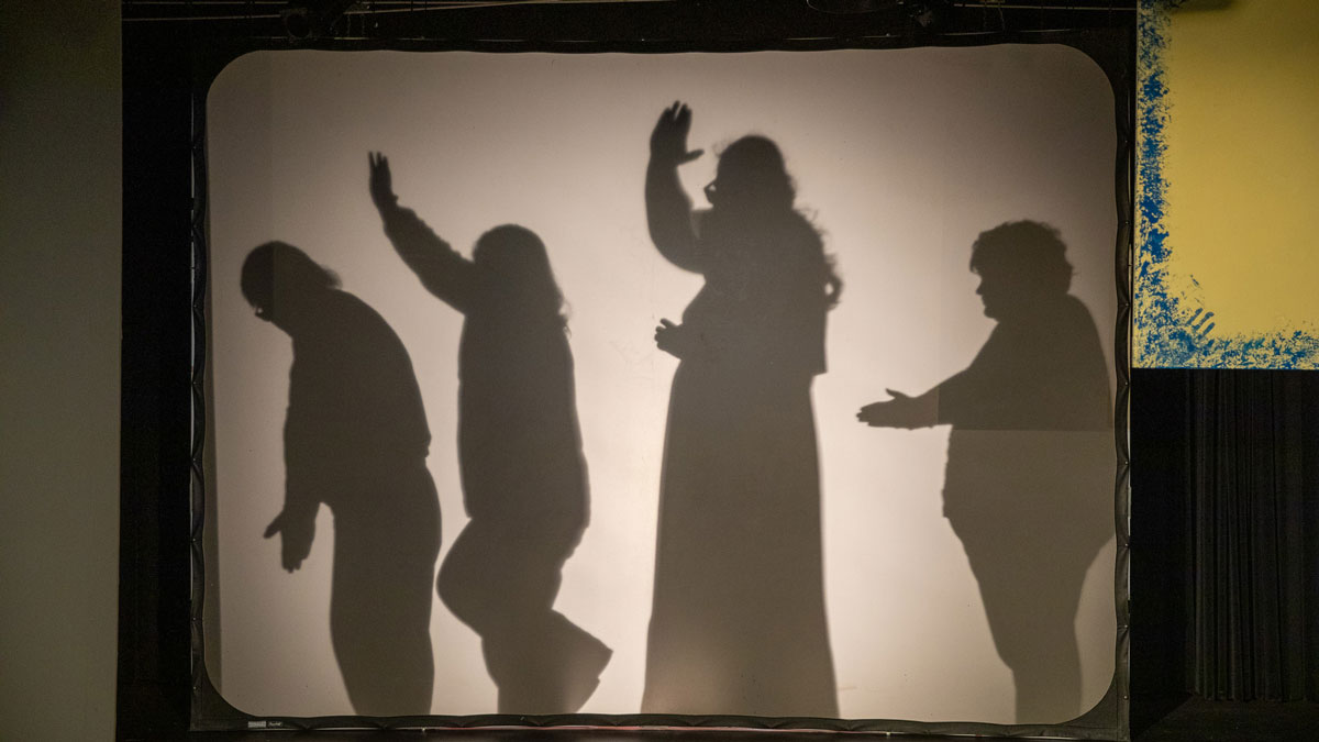Cast members rehearse a play.