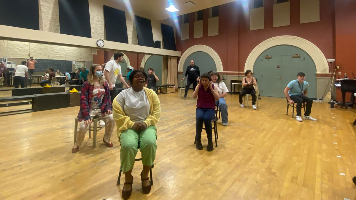 Cast members participate in play rehearsal.